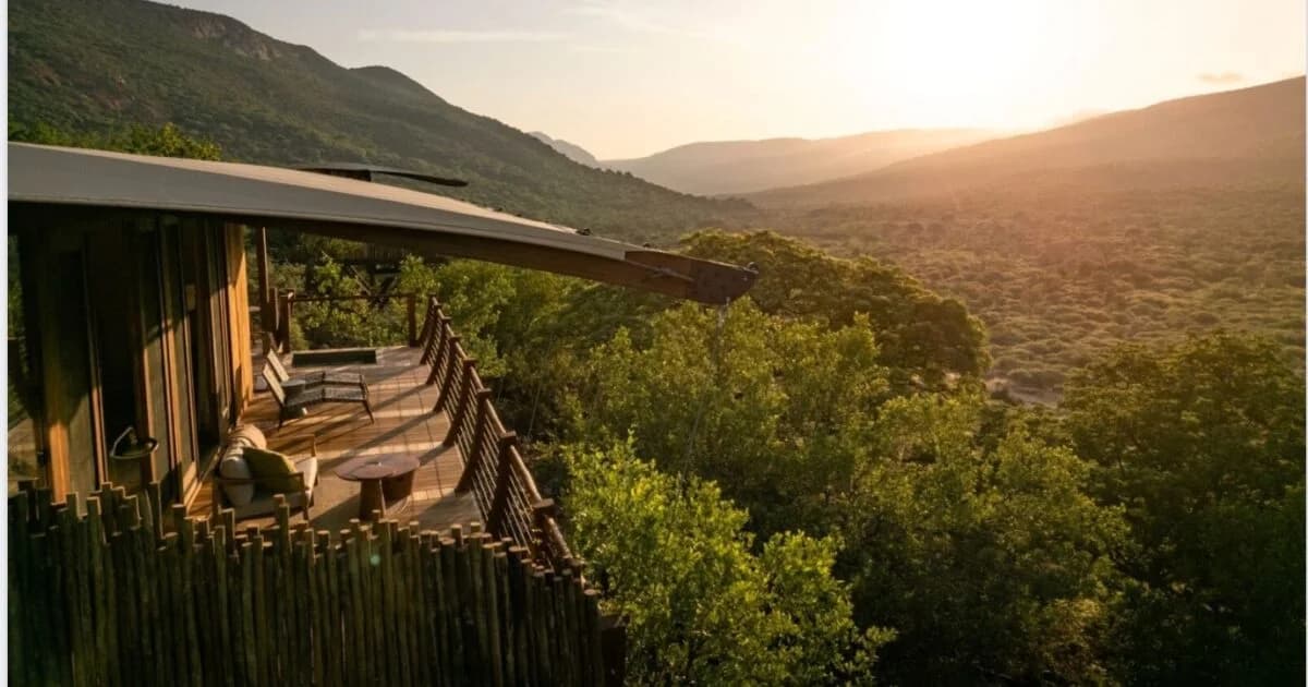 Lodge deck and mountain landscape in warm evening light, Few & Far nature and wellness experiences