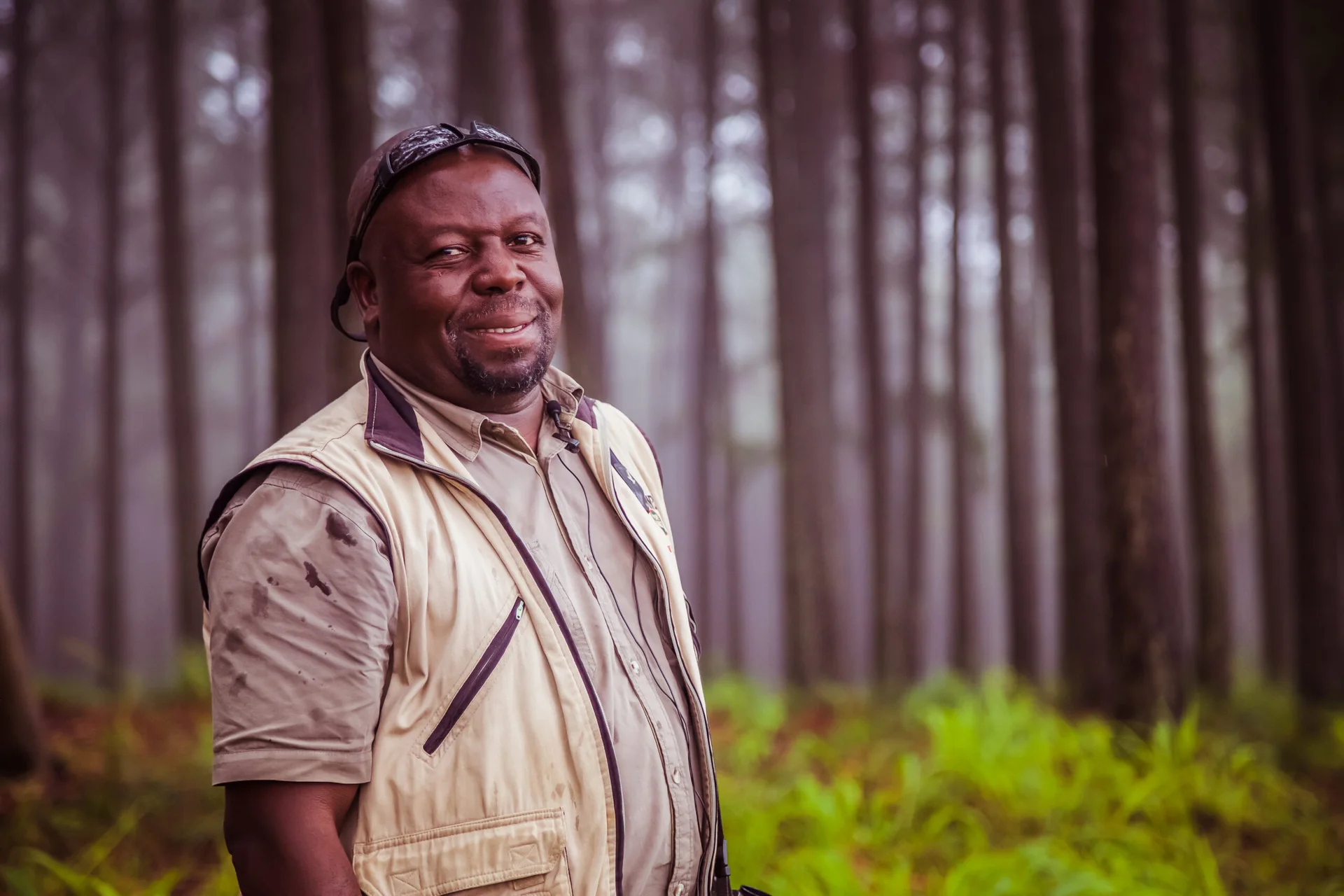 Bird guide wearing outdoor clothing in a forest, David Letsoalo birding