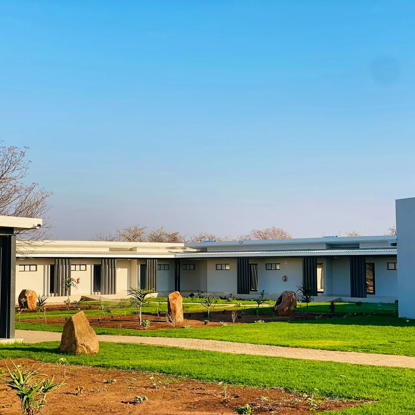 Guest-room buildings around a landscaped lawn, Alldays Country Lodge